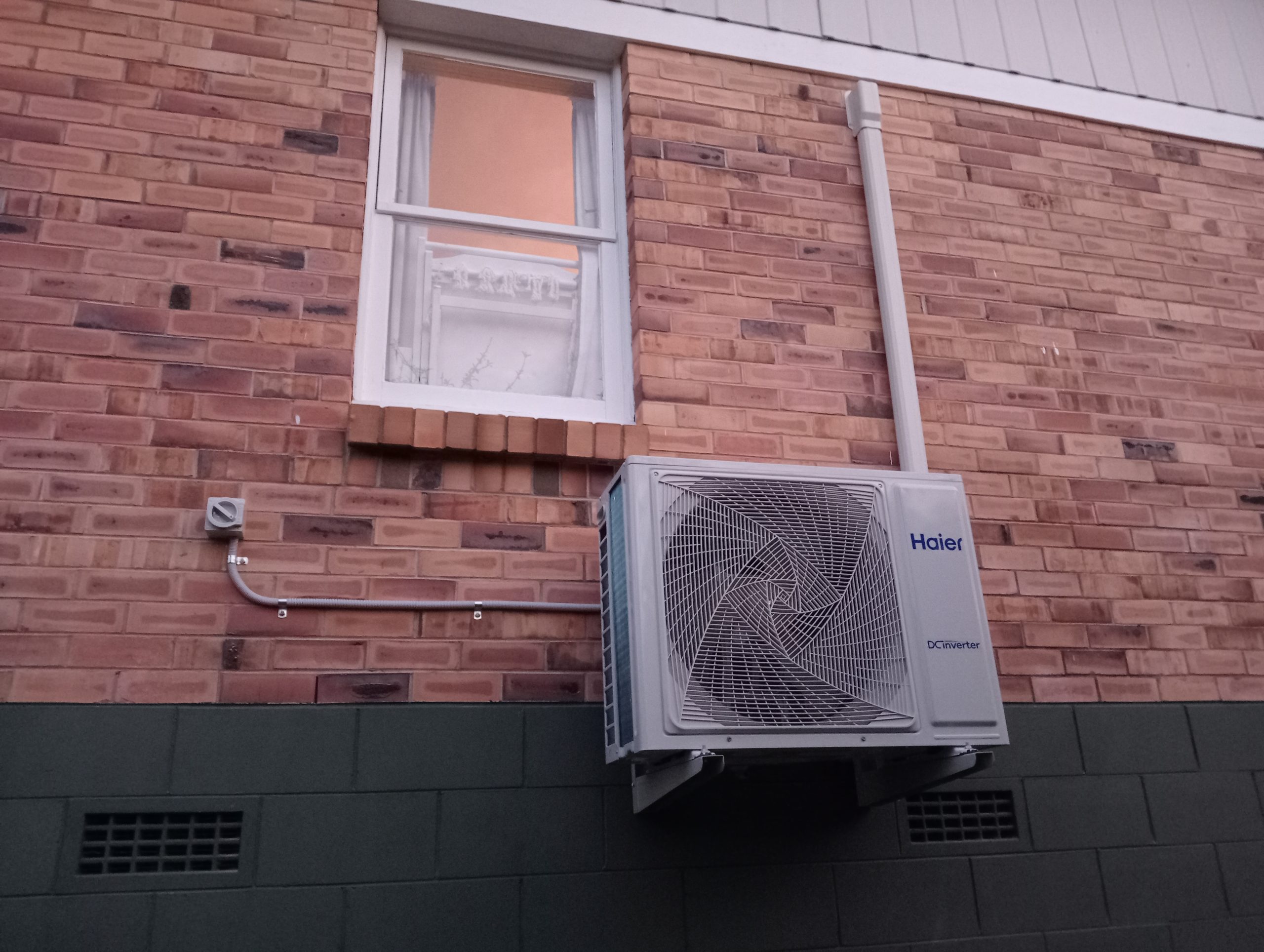 Evening photo of outdoor heat pump installation