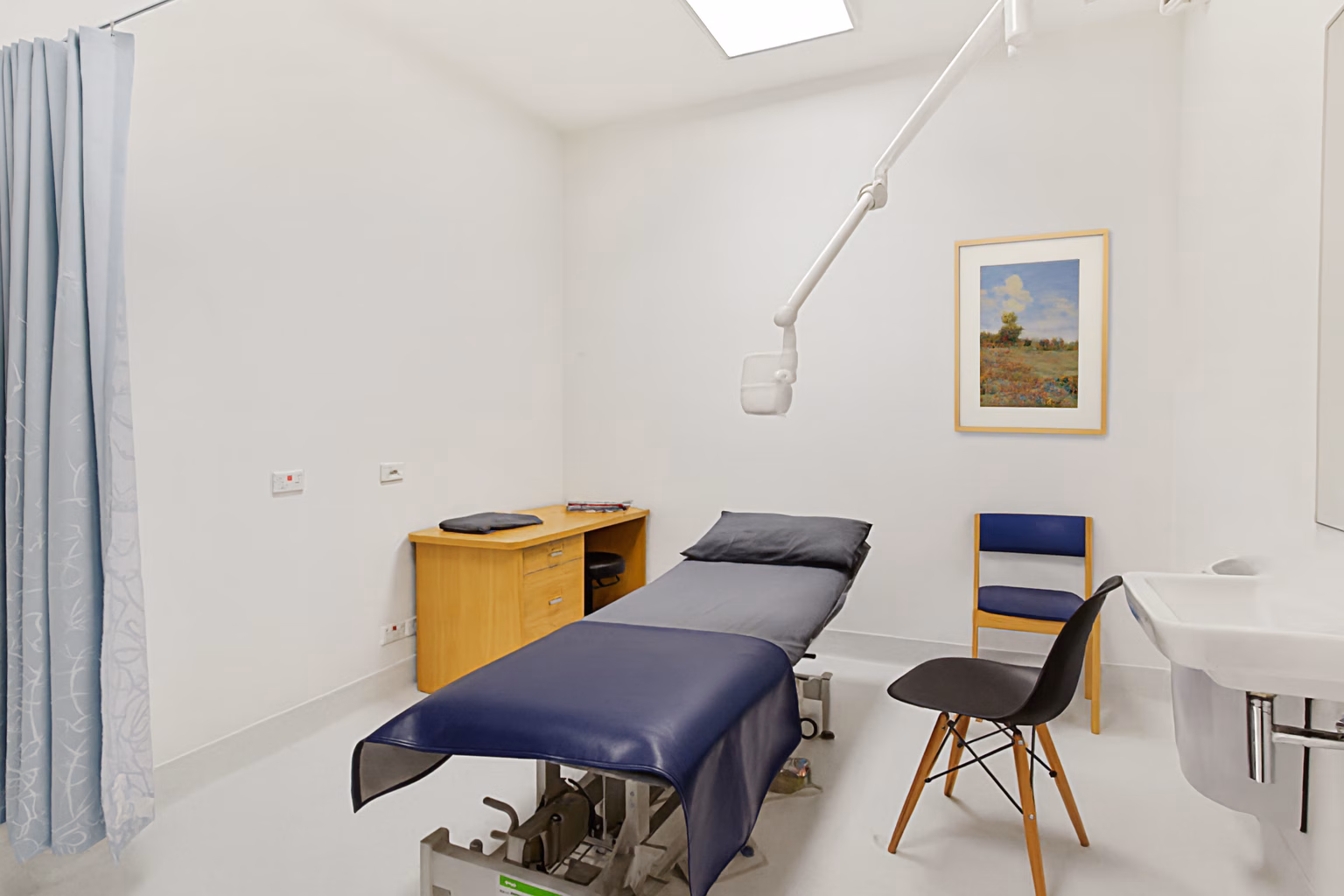 Bright GP consultation room with medical lighting